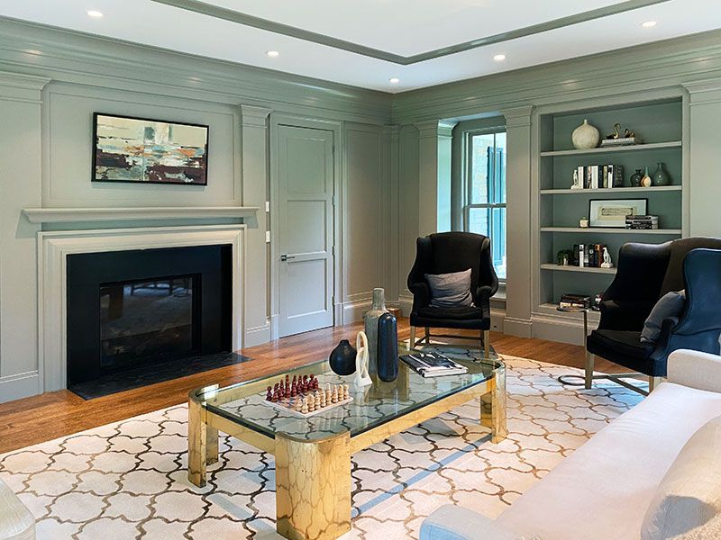 A living room with a couch , chairs , coffee table and fireplace.