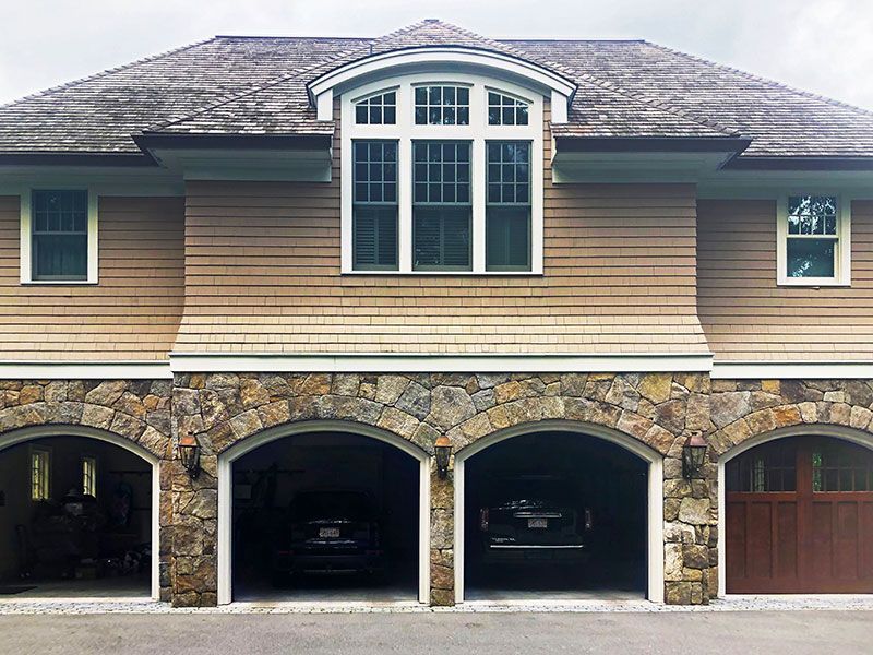 A large house with four garages and a large window