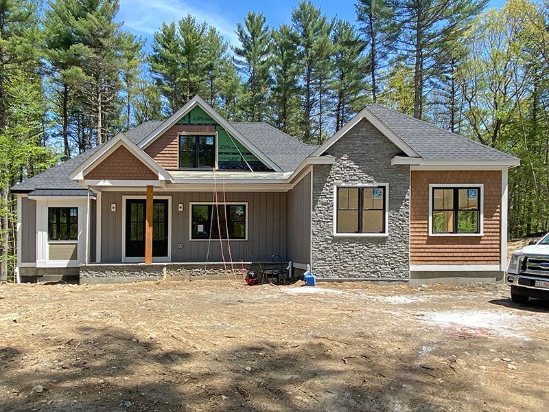 A large house is being built in the middle of a forest.