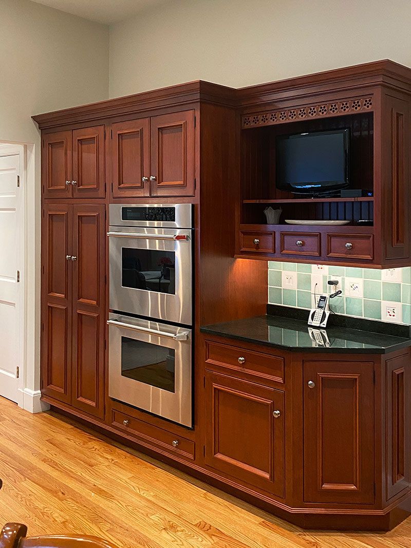 A kitchen with stainless steel appliances and wooden cabinets