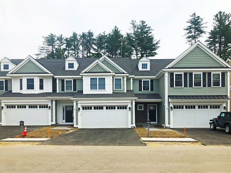 A row of houses with a jeep parked in front of them