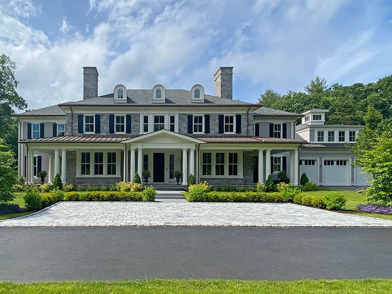 A large house with a driveway in front of it