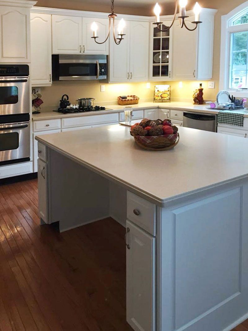 There is a large island in the middle of the kitchen.