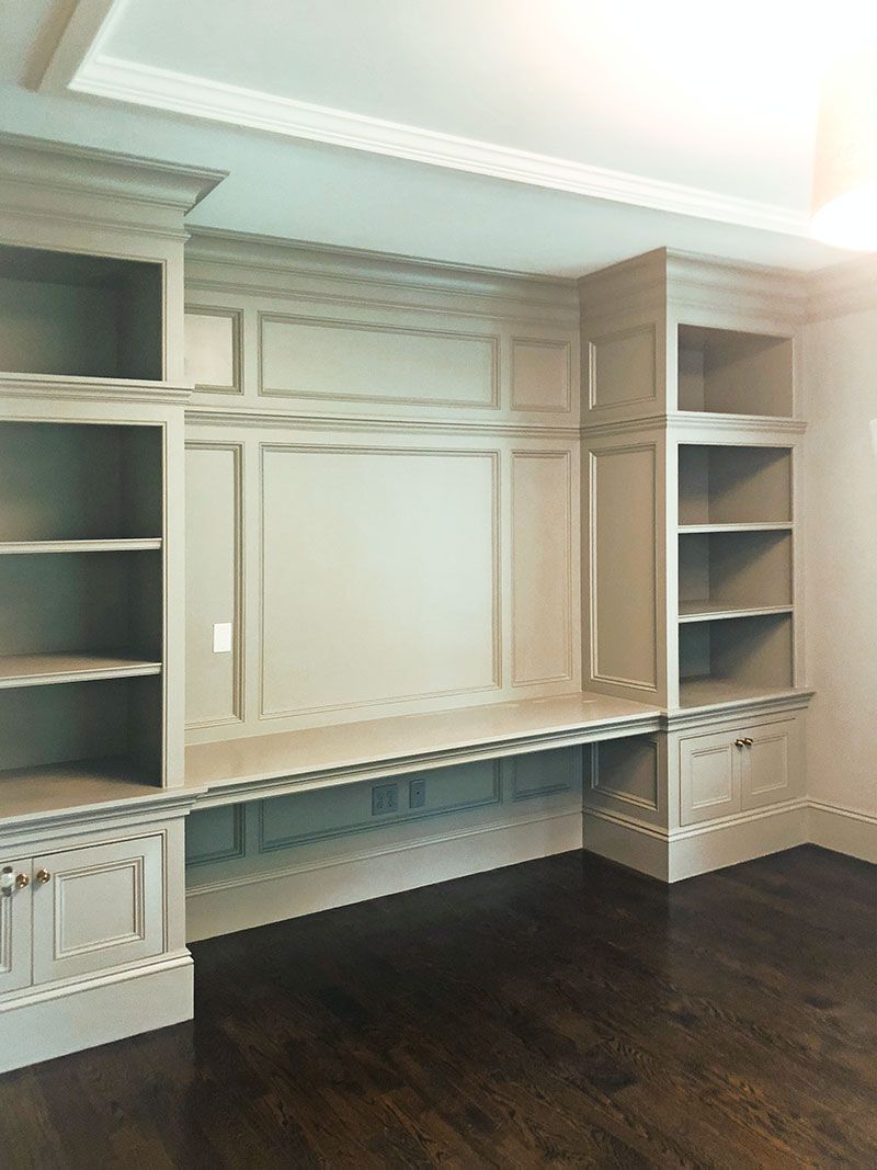 A room with a desk and shelves in it