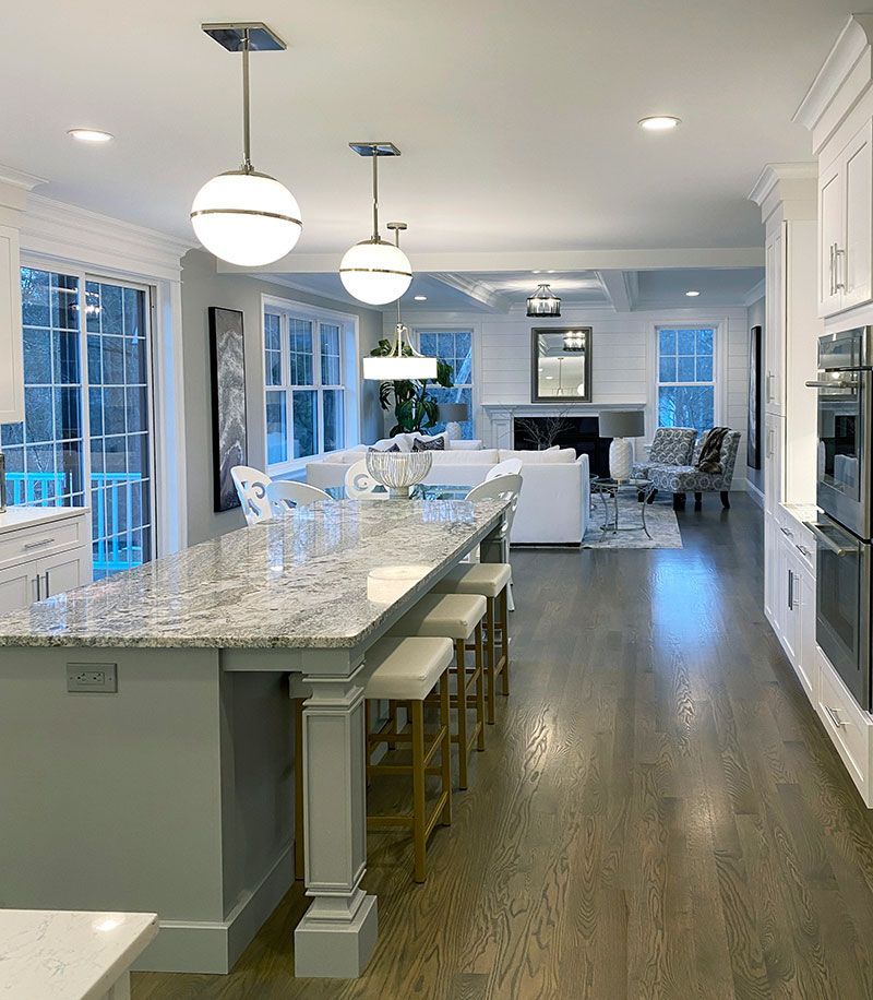 A kitchen with a large island and stools