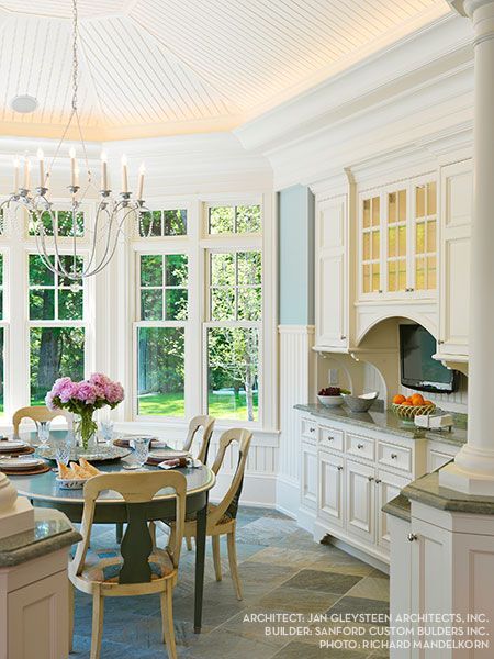 A kitchen with a table and chairs and a chandelier