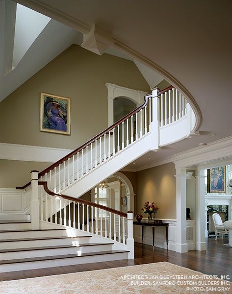 A staircase in a house with a picture on the wall above it