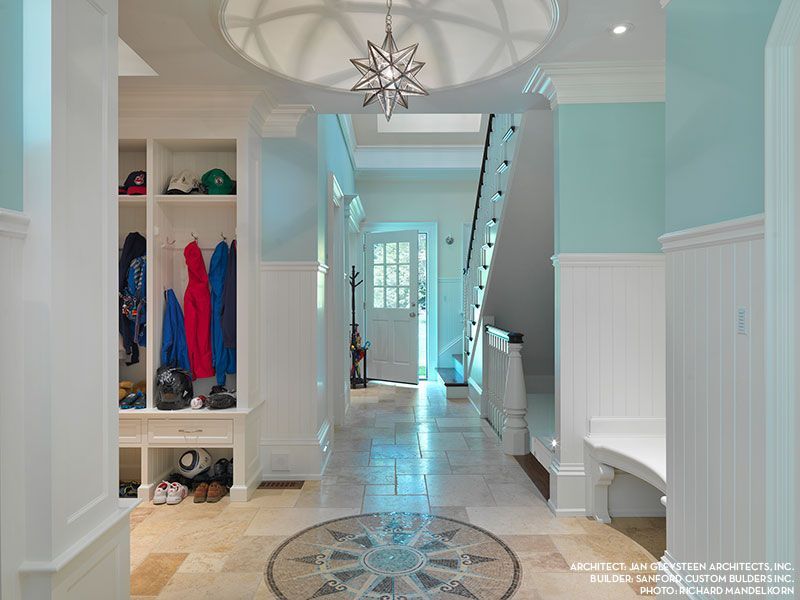 A hallway in a house with a star shaped chandelier hanging from the ceiling