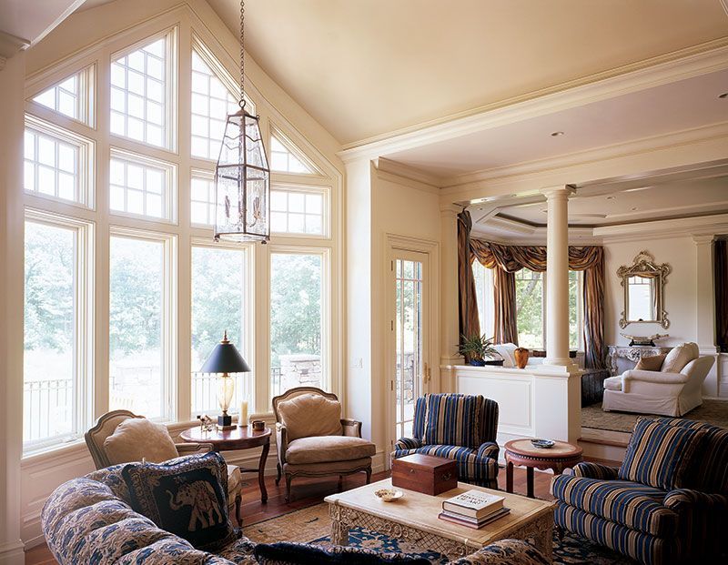 A living room with a vaulted ceiling and lots of windows