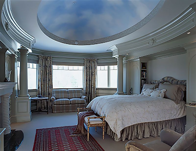 A bedroom with a large bed and a blue sky ceiling