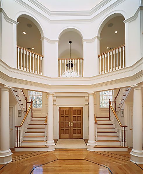 The inside of a building with stairs and arches