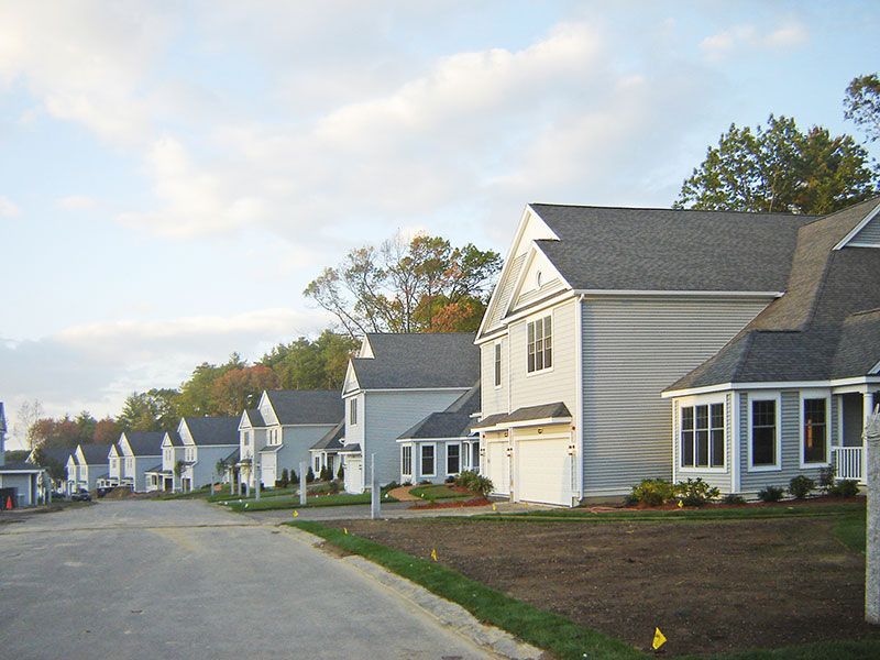 A row of houses are lined up on a street