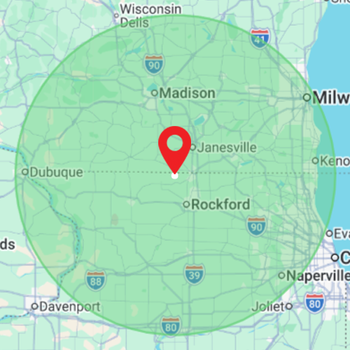 Green radius map centered on Janesville, Wisconsin, with a red location pin and nearby cities labeled.