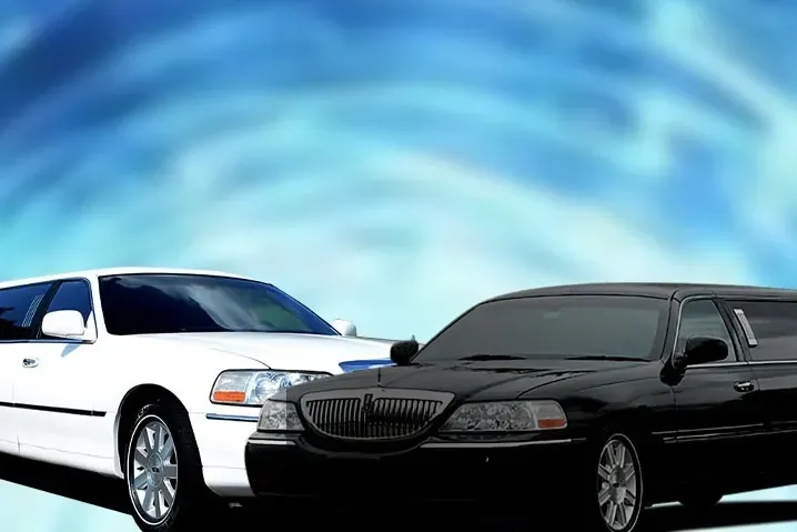 Two limousines, one white, one black, against a blue, swirly background.