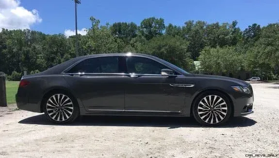 Dark gray Lincoln Continental sedan parked outside on a sunny day.