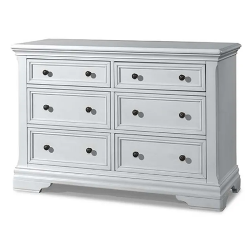 White dresser with six drawers, black knobs.