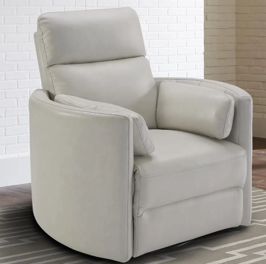 Gray leather recliner chair with curved arms and headrest, on a patterned rug.