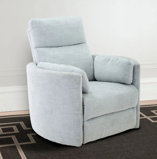 Light blue upholstered swivel recliner on a dark patterned rug in a room with a white wall.