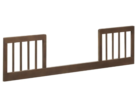 Brown wooden toddler bed rail with vertical slats.
