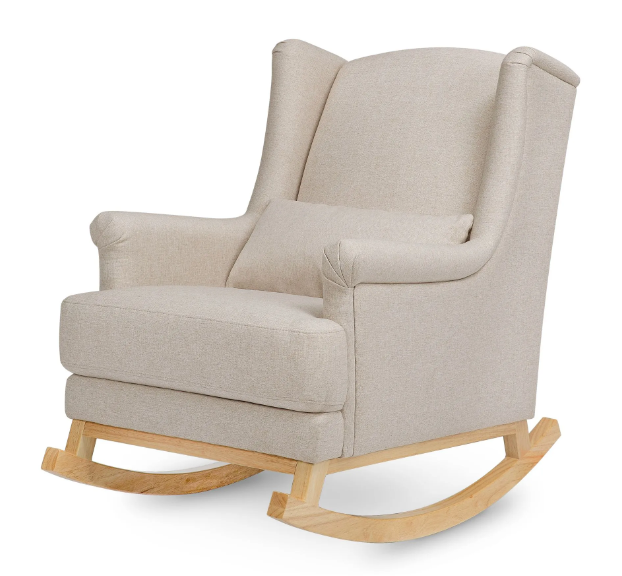 Beige upholstered rocking chair with wooden rockers and a small pillow.