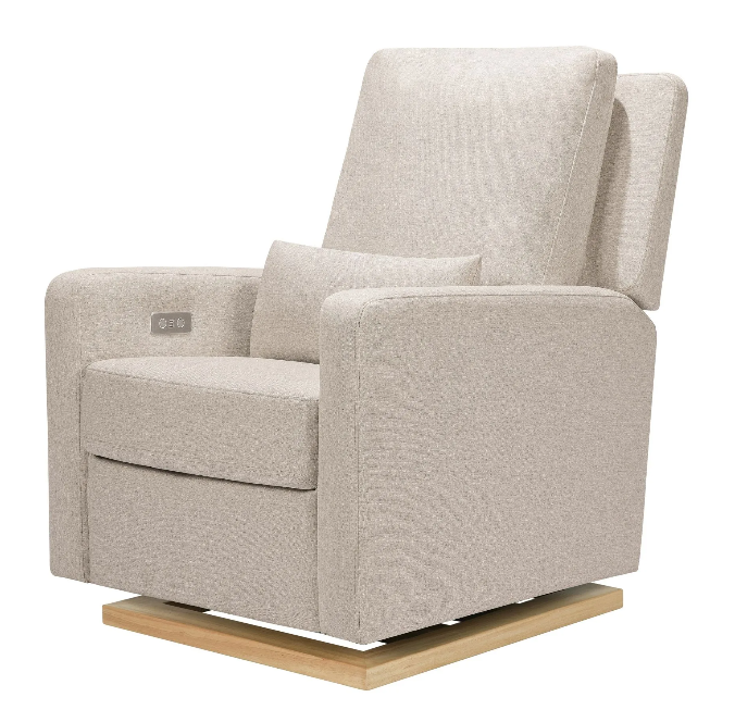 Tan upholstered recliner chair on a wood base, angled slightly. Includes a lumbar pillow and a charging port.
