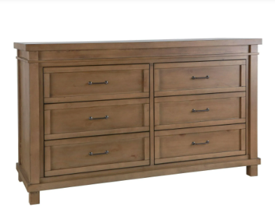 Wooden six-drawer dresser with dark hardware. Light brown finish with framed drawer fronts.