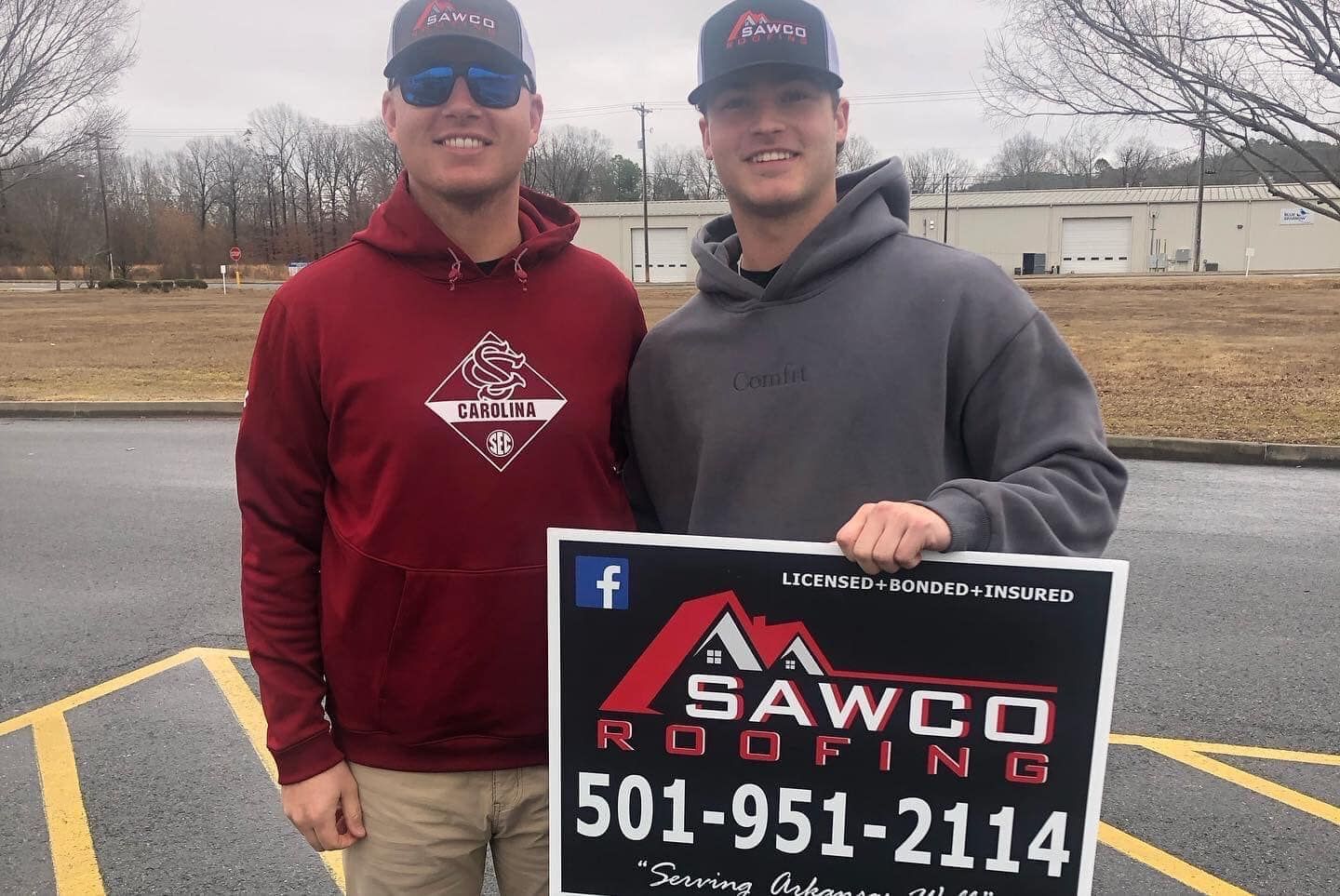two guys with a Sawco Roofing sign