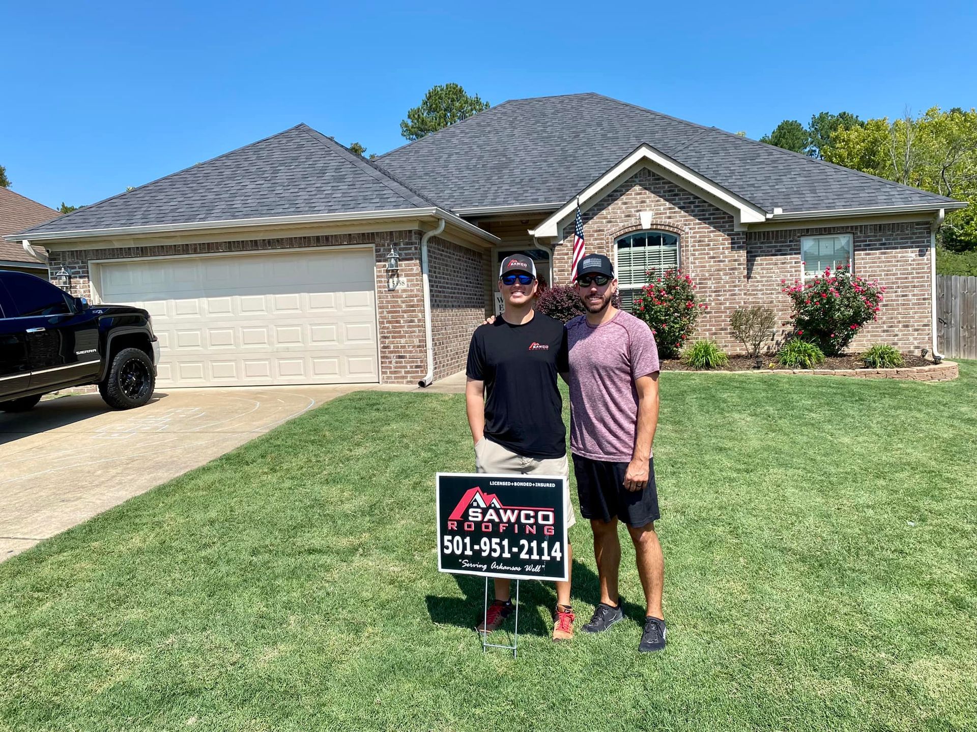 Sawco Roofing team on the front lawn