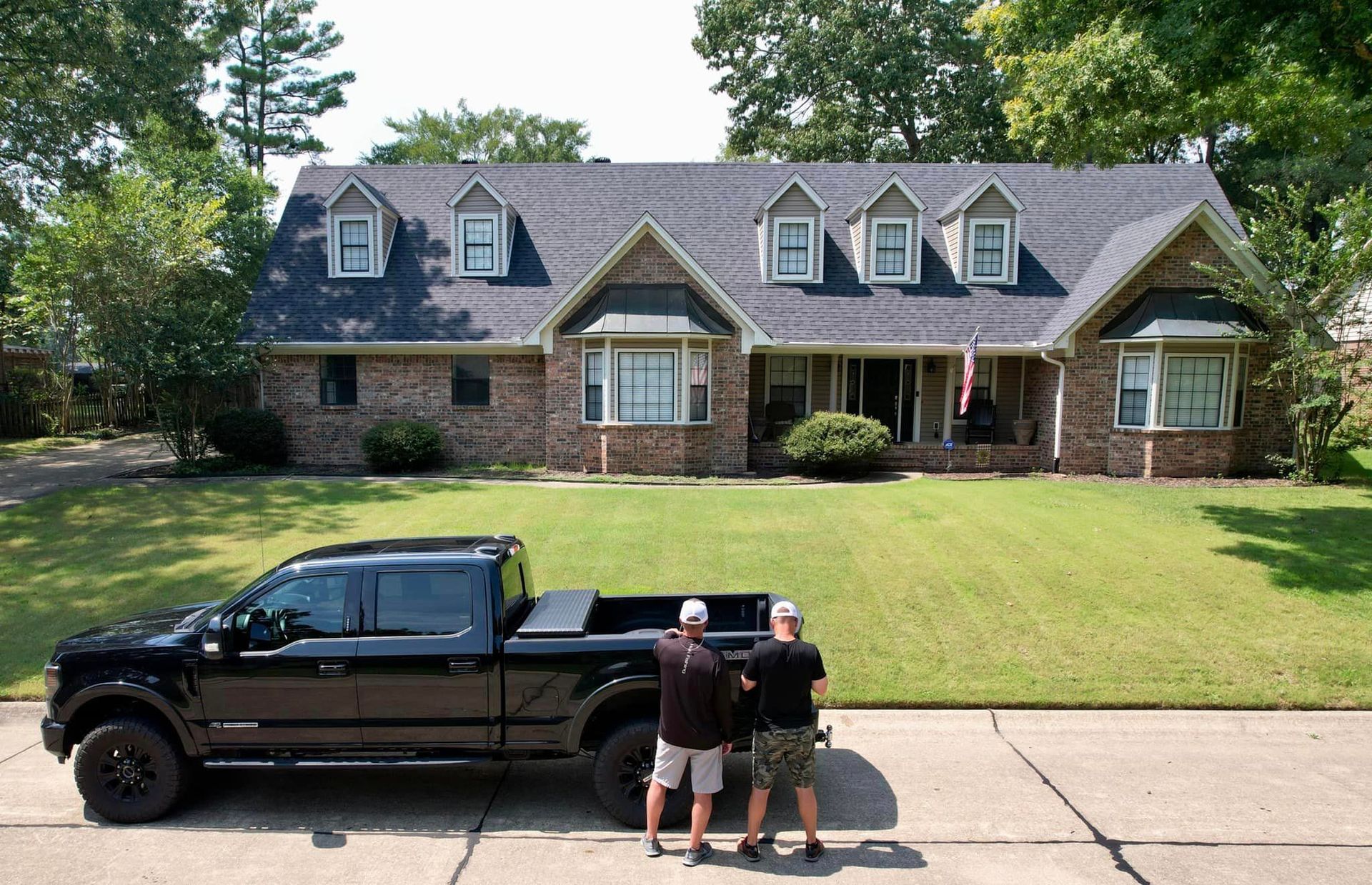 service truck in front of roofing project site