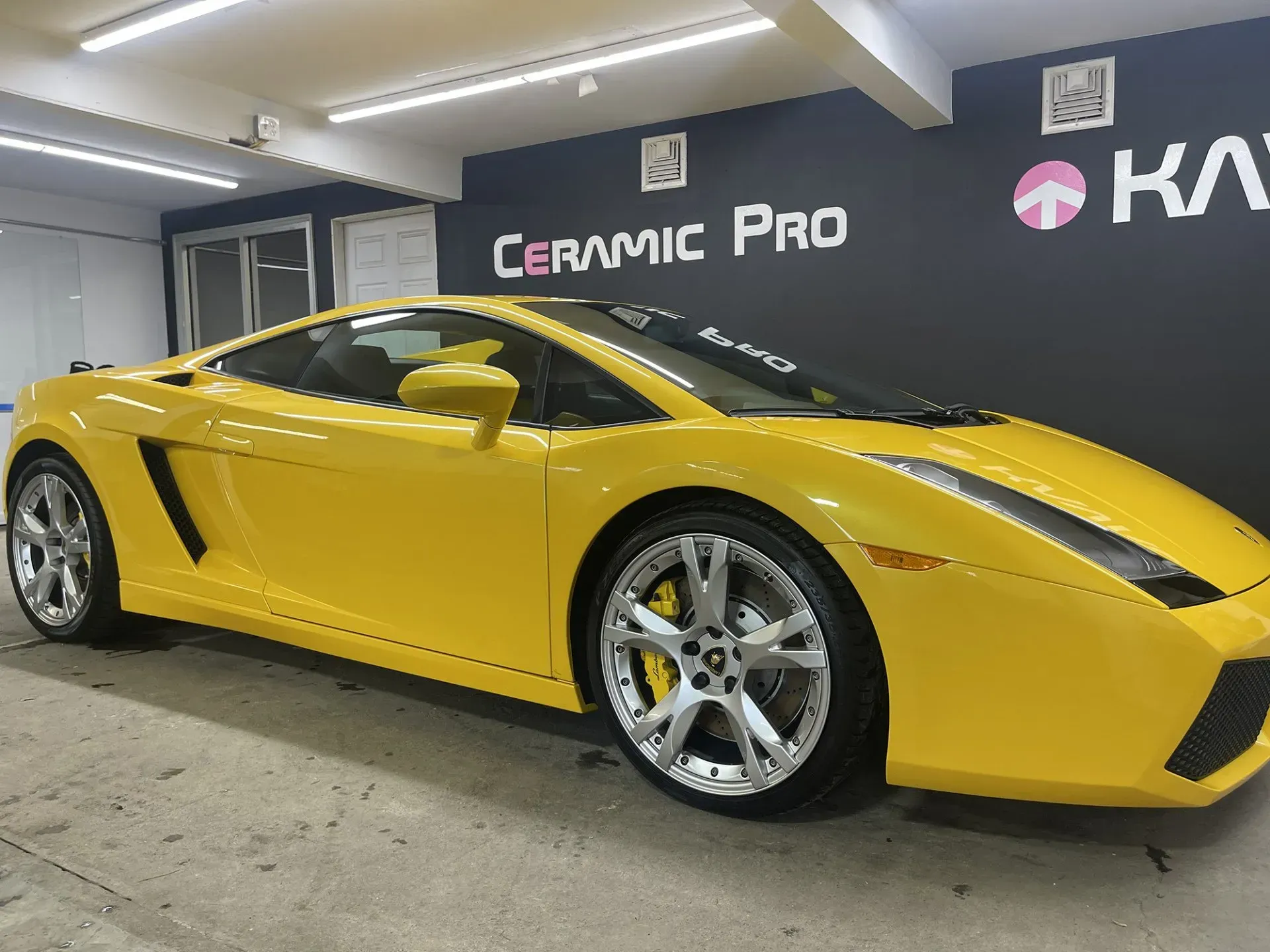 Yellow Lamborghini sports car parked in a garage with