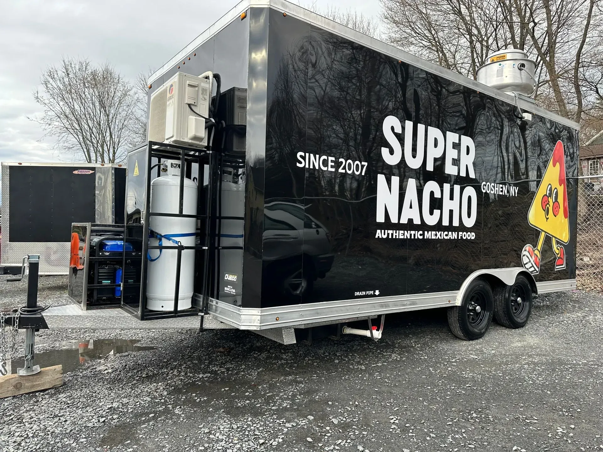 Super Nacho food truck on a trailer, black exterior with white lettering.