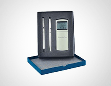 A box with two pens and a calculator in it