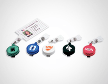 A bunch of badge reels are sitting next to each other on a table.