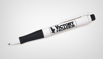A white pen with victory homes written on it