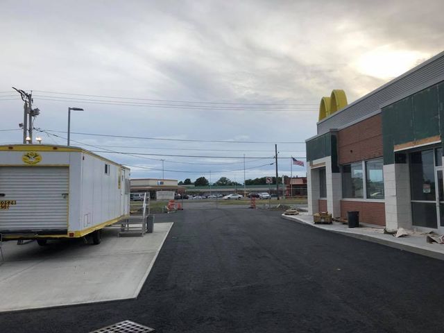A mcdonald 's with a trailer parked in front of it