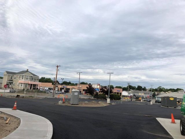 A construction site with a lot of cones on the side of the road.