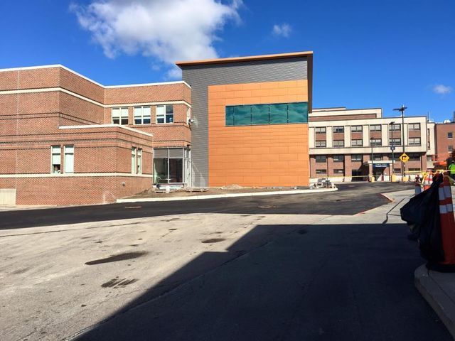 A large brick building with a green window on the side