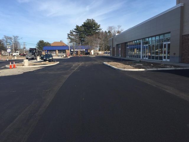 A road that is being paved in front of a building