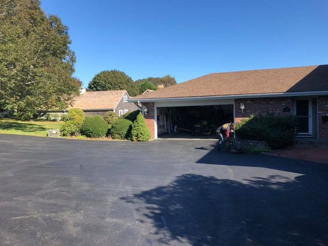 A house with a garage and a driveway in front of it