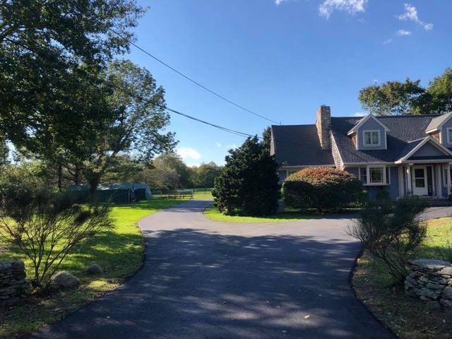 A large house with a driveway leading to it
