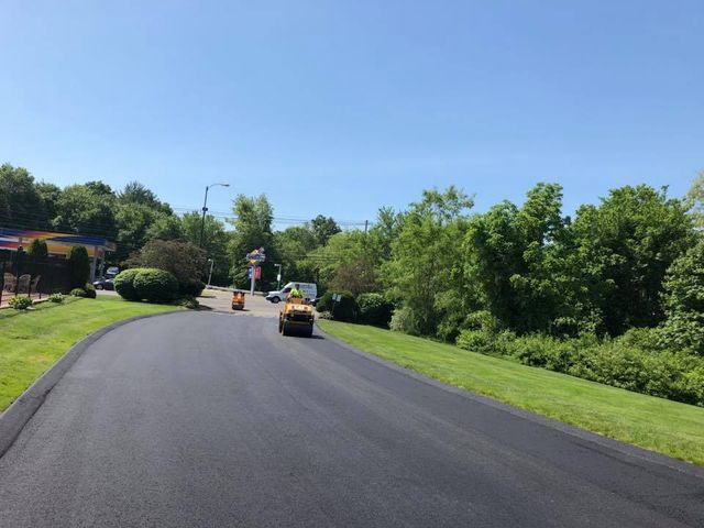 A road is being paved on a sunny day.