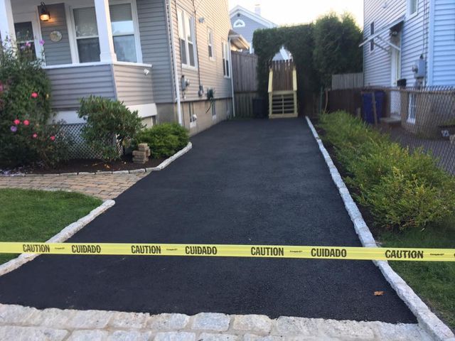 A driveway with a yellow caution tape on it