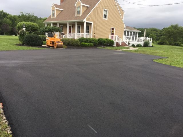 A large house with a large driveway in front of it.