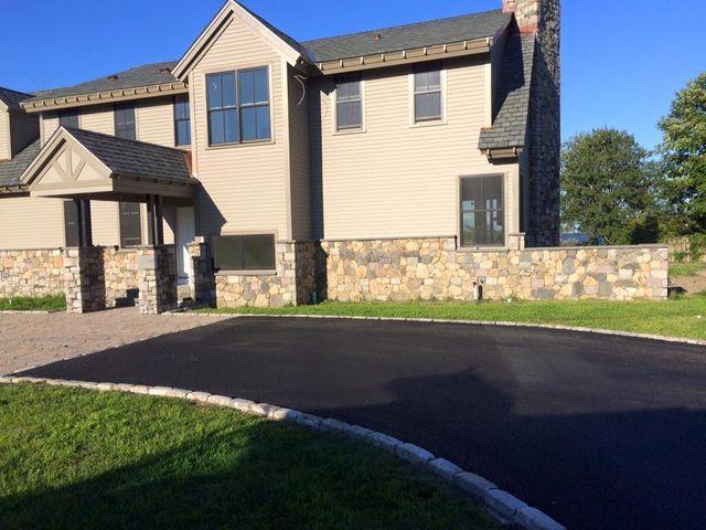 A large house with a driveway leading to it