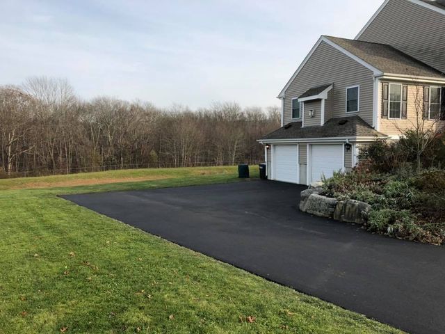 A large house with a large driveway in front of it.