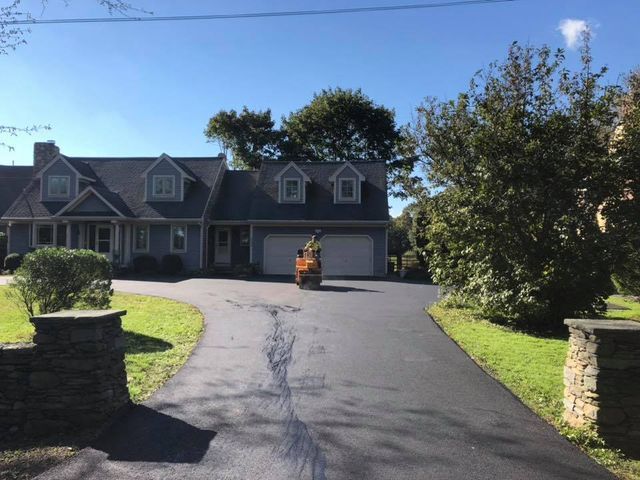A large house with a driveway leading to it