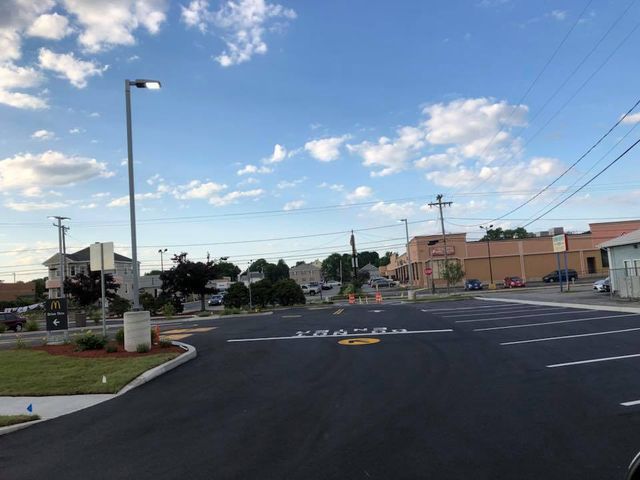 A street with a yellow arrow pointing to the right