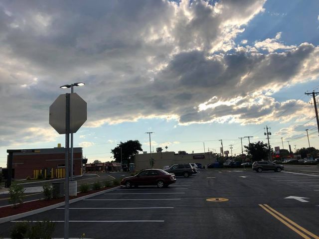 A parking lot with a stop sign in the foreground