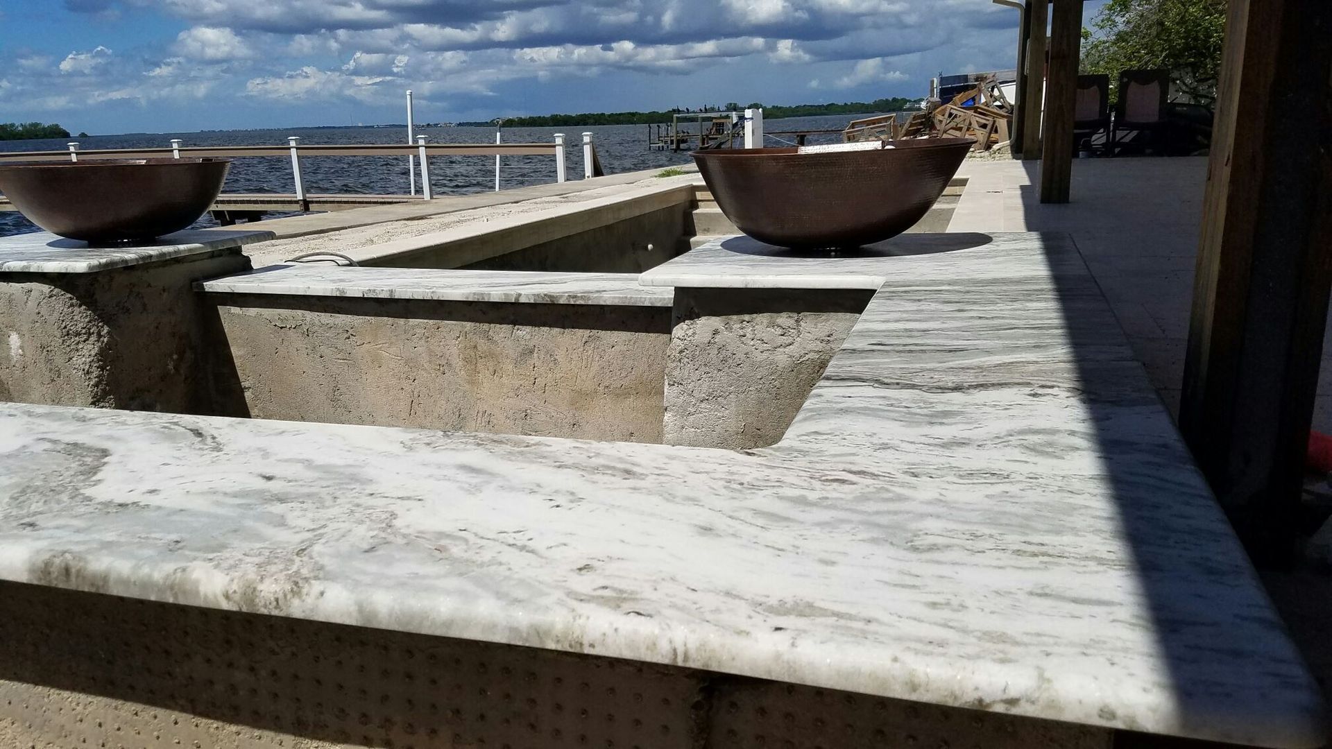 Two bowls are sitting on top of a marble counter top.
