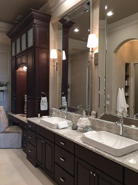 A bathroom with two sinks and a large mirror